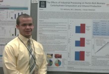 Travis Williams with poster at SEC Symposium