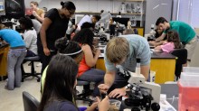 UGA Microbiology graduate students working with members of Girls Inc in the lab